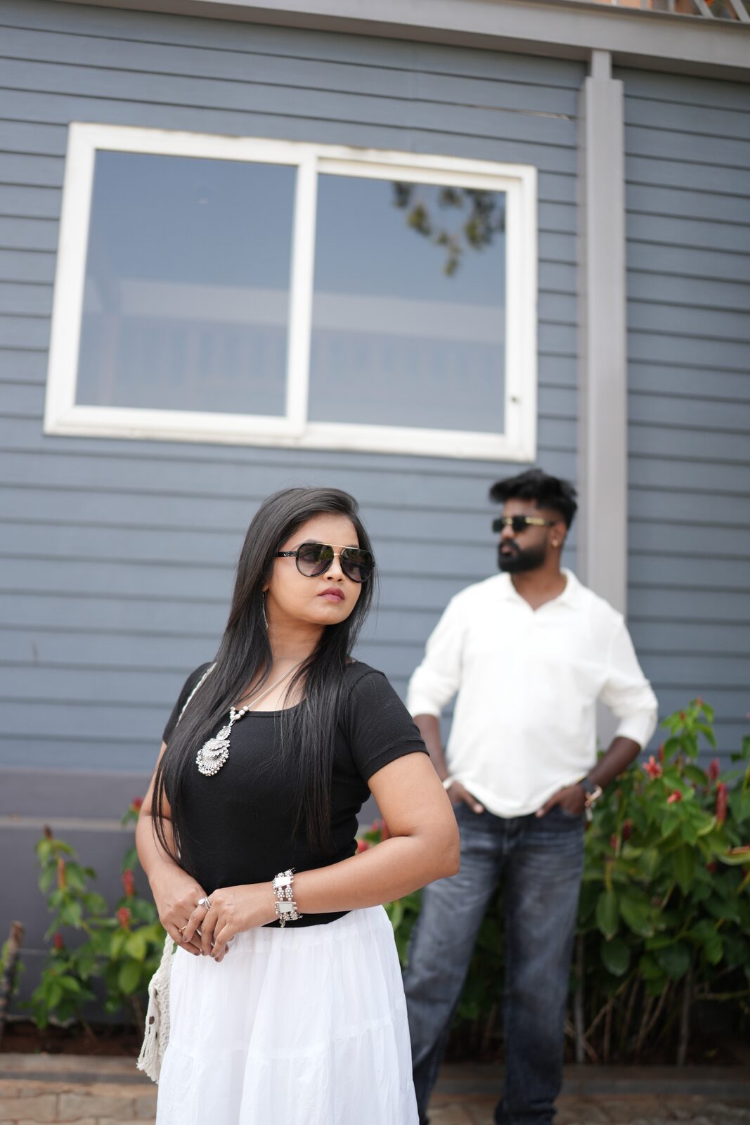 Karthik and Deeksha by a blue wall