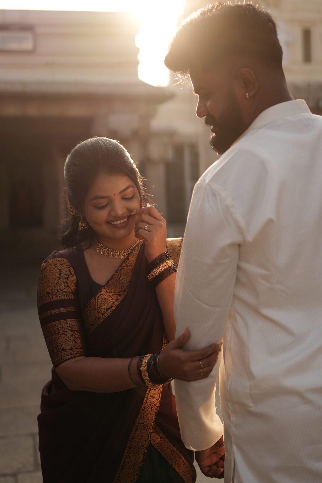 Deeksha smiling beside Karthik