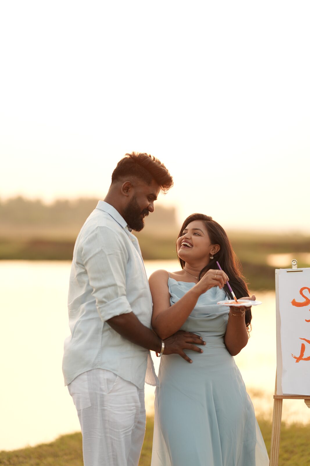 Karthik and Deeksha laughing by the lake