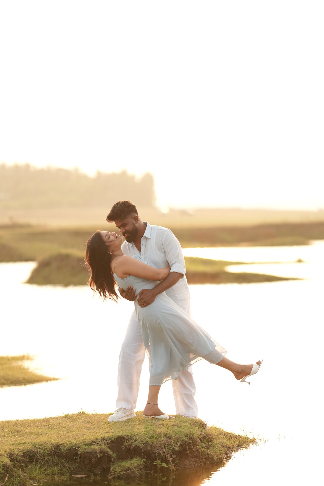 Karthik dipping Deeksha on a grassy bank