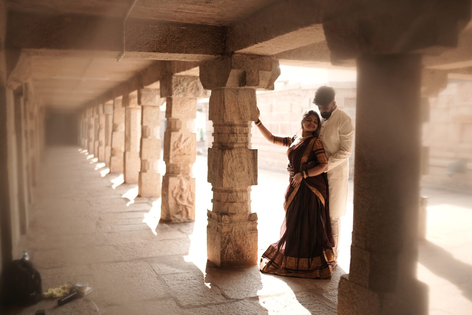 Karthik and Deeksha in a stone colonnade